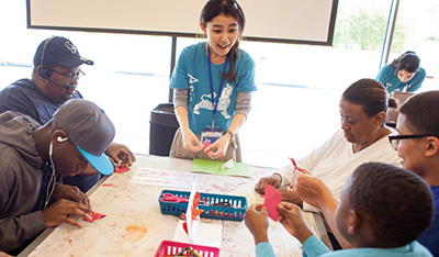 Photo of coordinator presents spring-themed origami (paper folding) and creates Mother’s Day cards with carnations