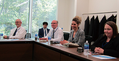 Photo of visitors listen to an explanation during a company visit