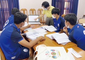 Photo of a teacher introducing Irodori  and studentsat a soccer academy in Cambodia