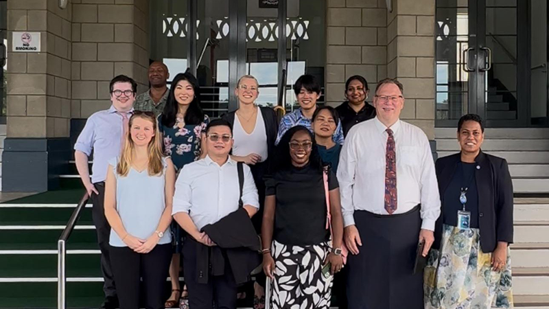 Indoors, participants sit facing each other in a circle and engage in discussion.