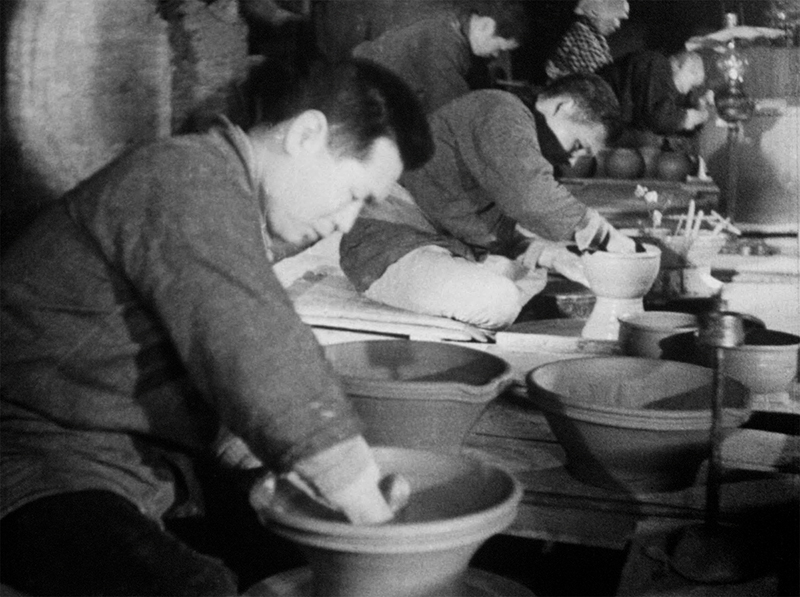 1937年益子村にて、男性が手作業で陶器を作っている様子の白黒写真。