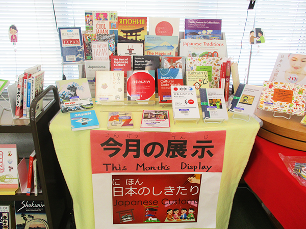 図書館の隅の小さなテーブルに、1月の展示テーマである「日本のしきたり」に関する本が20冊以上並んでいる。