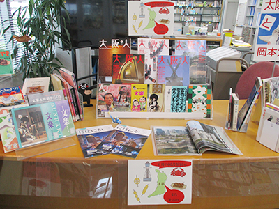 Another table is decorated with numerous books on 