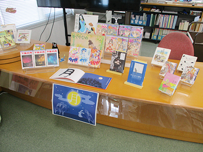 Another table also displays numerous books related to the moon.