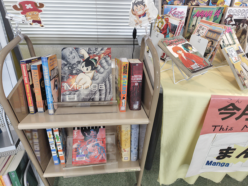 海外向けに翻訳された「マンガ」がテーブルの横にある小さなラックに並んでいる。