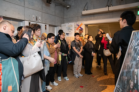 ユーロスペースに訪問している外国人約13人と、案内をしている1人が写っている。