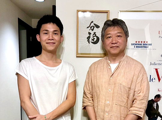 Two-shot indoors. Director Pat Bunnitipat on the left, Director Koreeda on the right