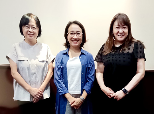 Three women taking a commemorative photo