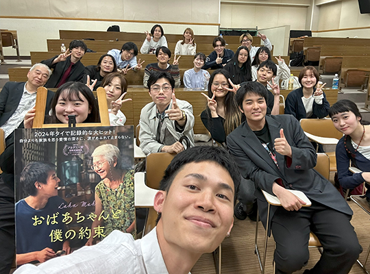 Director Pat Boonnitipat with students in a stepped classroom