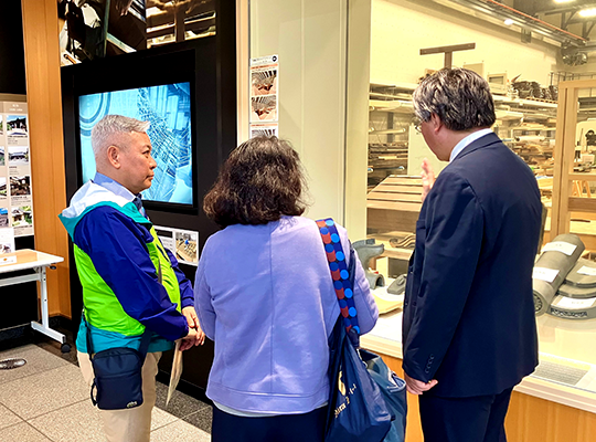 A man listening to an explanation of an exhibit inside the facility