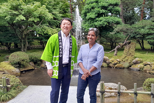 A photo of Bella Galhos and a man at Kenroku-en Garden.