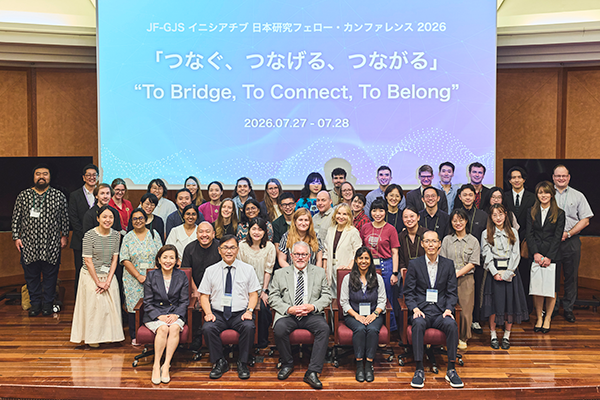Group photo of conference participants on stage