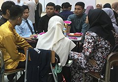 Picture of first-year students listen to senior students with serious expression