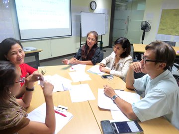 Picture of participants consider a discussion topic